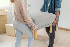 Moving house, relocation. Couple hold key for new house, inside the room was a cardboard box contain personal belongings. move in the new apartment or condominium. move furniture. photo