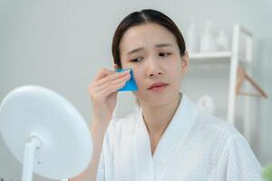 Oily face problem, Woman worried about face Dermatology, large pores, uneven face, sensitive skin, red face from sunburn, acne, dry skin, large pores ,rash face, dull, freckles, wrinkle, skin problem photo