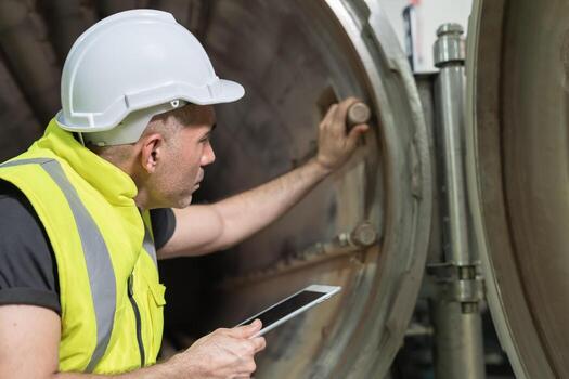 Engineers or utility staff wearing safety helmet fix the machines in the production line. Utility inspector check machine and test the system to meet the standard. machine, Preventive photo