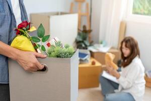 Moving house, relocation. Husband holding carton box on new apartment or home, inside the room was a cardboard box containing personal belongings and furniture. move in condominium photo