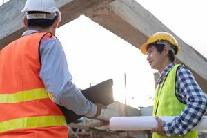 inspector or engineer construction and quality assurance new house using computer. Engineers or architects or contactor work to build the house before handing it over to the homeowner photo