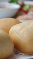 What buns female hand touching airy vietnamese bun showing structure three on white baking plate video