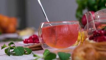 Cherry tea stir spoon fruit mint sweet fruits with tea pot on wood 1920x1080 intro motion slow hidef video