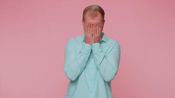 Upset disappointed man alone wipes tears and cries from despair, being sad because of unfair things. video