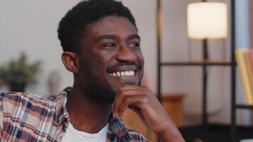 Happy calm young african american bearded man smiling looking away dreaming resting, feel satisfied. video
