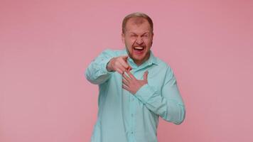 Man pointing finger to camera, laughing out loud, making fun of ridiculous appearance, funny joke. video