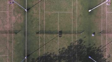 Aerial view of a tennis court complex in Ayia Napa, Cyprus, surrounded by red bougainvillea, parking areas, and pathways, with slow drone motion. video