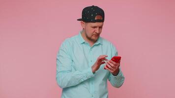 Adult man using mobile phone typing post on web sms message browsing addiction of social networks. video