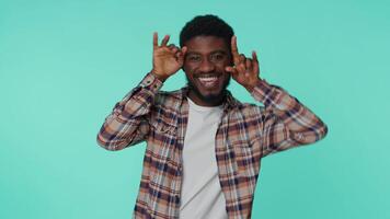 Funny joyful man making playful silly facial expressions, grimacing fooling around showing tongue. video