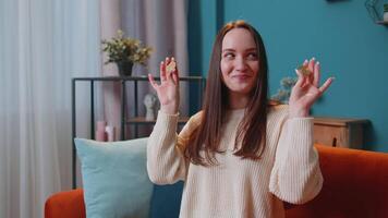 Woman freelancer holding two gold coins BTC at home, successful developer programmer stock trader. video