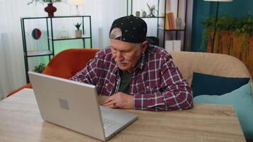 Amazed senior grandfather use laptop computer, receive good news message, shocked by sudden win, wow. video