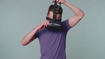 Man using virtual reality futuristic technology VR headset helmet to play simulation 3D game. video