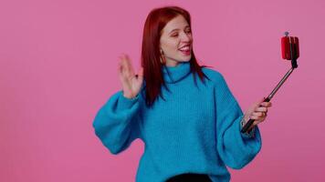 Adult girl blogger taking selfie on mobile phone, communicating call online with subscribers. video