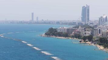 Aerial view of Limassol, Cyprus, featuring a slow pan across high rise towers, a stepped structure, and a mix of modern and traditional architecture. video