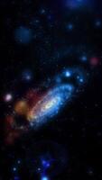 A bright, neon-blue, three-dimensional spiral galaxy quickly and dynamically changes its position, appearing before us in beautiful, unexpected angles. video