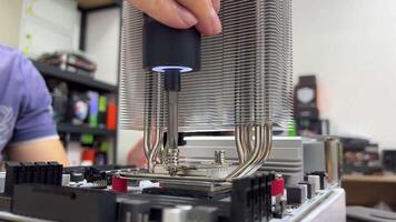 Assembling a computer with a motherboard in an electronics repair lab using troubleshooting and maintenance tools and components video