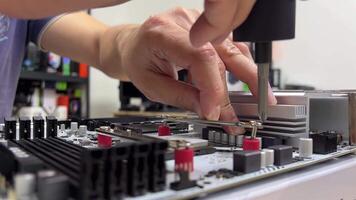 Repair of an appliance with a motherboard in an electronics repair laboratory using troubleshooting and maintenance tools and components video