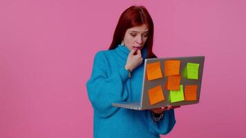 Exhausted woman freelancer with pasted sticker notes using laptop computer, concentration problem. video
