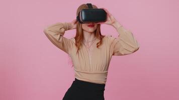 Girl using virtual reality futuristic technology VR headset helmet to play simulation 3D game. video