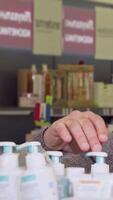 Senior man multitasking on a phone while exploring vibrant pharmacy products video