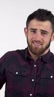 Bearded man grimacing while covering his ears from overwhelming noise video