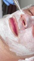Handsome man blissfully indulging in a rejuvenating facial mask at a tranquil spa video