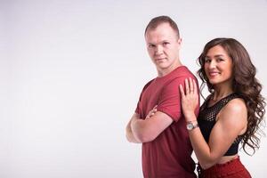 Portrait of young healthy sporty couple hugging on white background with copy space. photo