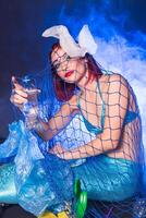 Ocean pollution, rubbish in the water. Fairytale mermaid in dirty ocean. Plastic trash and garbage in water. Environmental problem, plastic bag and bottles polluting planet. photo