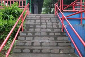 Concrete Stairs with Red Handrails in Outdoor Public Area photo