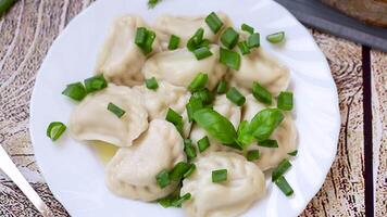 Appetizing dumplings with potatoes and onions on a rustic table video