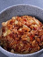 a bowl of rice and beans with a spoon photo