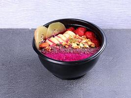 a bowl of food with fruit and nuts photo