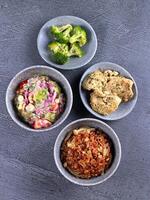 four bowls of food on a table photo