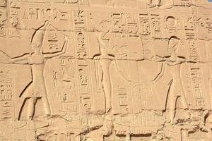 Ancient egyptian hieroglyphs on the wall of karnak temple in Luxor, Egypt. photo