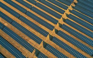 Aerial view of rows of solar panels installed on a vast field. photo