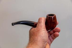 Hand holding luxurious pipe in selective focus and smooth background xr3 photo