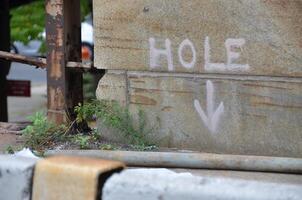 Warning Sign on Weathered Stone Wall photo