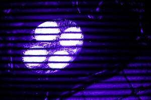 A close-up view of a four LED Spot, illuminated ultraviolet light at 50Hz creating a striking purple flicker effect photo