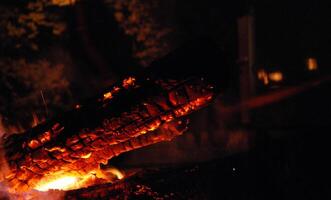 Glowing Log in Campfire at Night photo