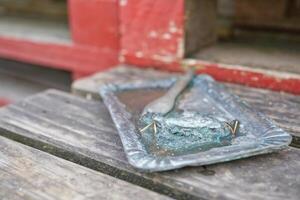 Rustic Metal Tray with Fork and Blue-Green Material photo