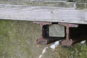 Rusty Metal Rail with Wooden Block photo