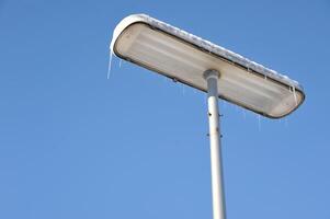Snowy Street Lamp Under Clear Blue Sky photo