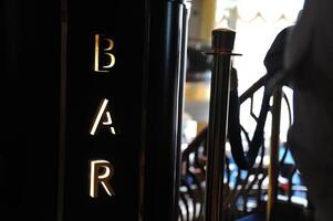 Illuminated Bar Sign in Lively Restaurant photo