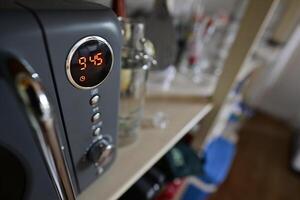 Closeup of Microwave Oven Displaying Time 9 45 photo