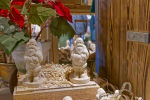 Wooden Santa Claus Figurines on Rustic Shelf photo