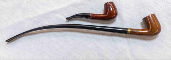 Hand holding luxurious pipe in selective focus and smooth background 2 photo