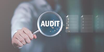 business document evaluation process, market data report analysis and consulting,Businessman holding a magnifying glass, showing Audit Document concept,quality assessment management With a checklist photo