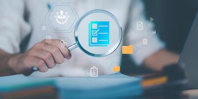 Management of important document storage of organization ,ERP document system ,quality assessment management With a checklist ,online document database ,Auditor worker working with document folder photo