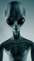 3D rendering. Scary gray alien stands and looks blinking on a dark smoky background. UFO concept. video