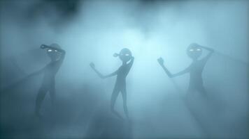 3D rendering. Scary aliens dancing on a dark smoky background. video